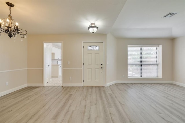 12210 High Meadow Ct, Oklahoma City, OK 73170 - entrance foyer with light wood-style flooring, a chandelier, and healthy amount of natural light