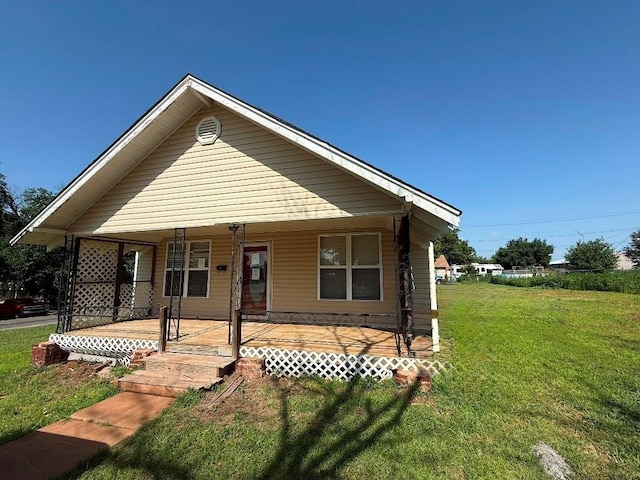 223 N Market St, Cordell, OK 73632 - view of front facade with covered porch and a front lawn