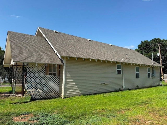 223 N Market St, Cordell, OK 73632 - view of side of property with roof with shingles and a yard