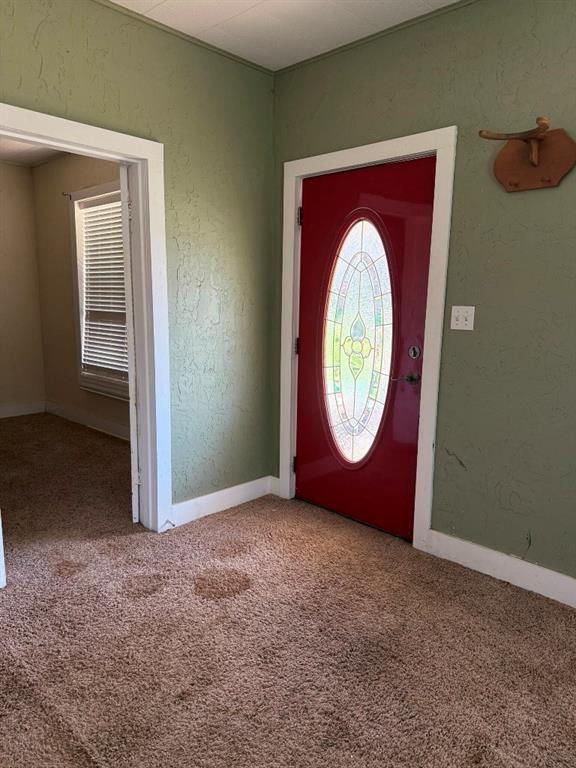 223 N Market St, Cordell, OK 73632 - carpeted entryway featuring baseboards