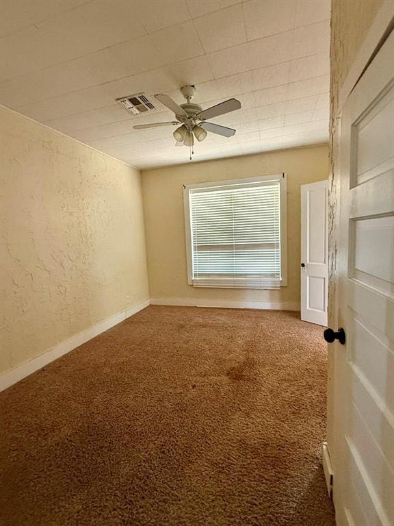 223 N Market St, Cordell, OK 73632 - spare room featuring carpet flooring, ceiling fan, and a textured wall