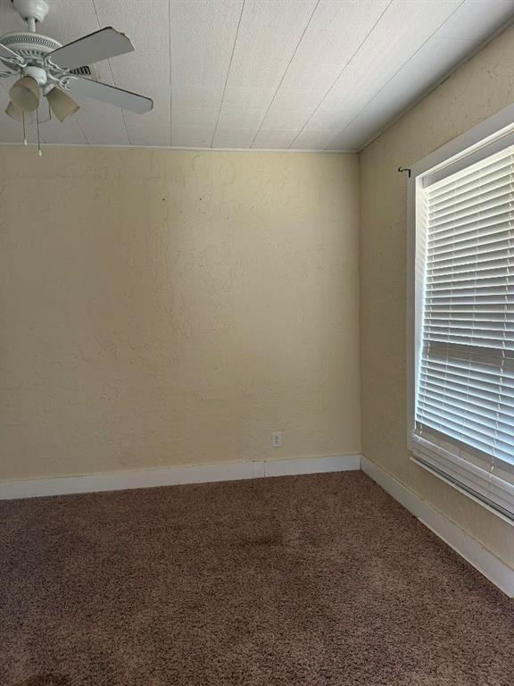 223 N Market St, Cordell, OK 73632 - unfurnished room featuring carpet floors and ceiling fan