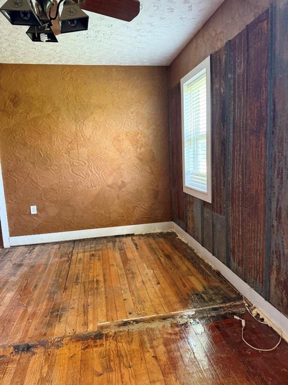 223 N Market St, Cordell, OK 73632 - empty room with hardwood / wood-style flooring and baseboards