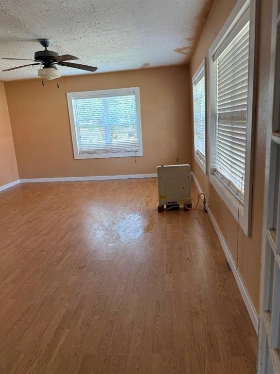 223 N Market St, Cordell, OK 73632 - unfurnished room with wood finished floors, a ceiling fan, and a textured ceiling