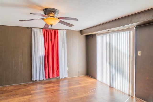 2728 NE 99th St, Oklahoma City, OK 73131 - unfurnished room with ceiling fan, wood finished floors, and wood walls
