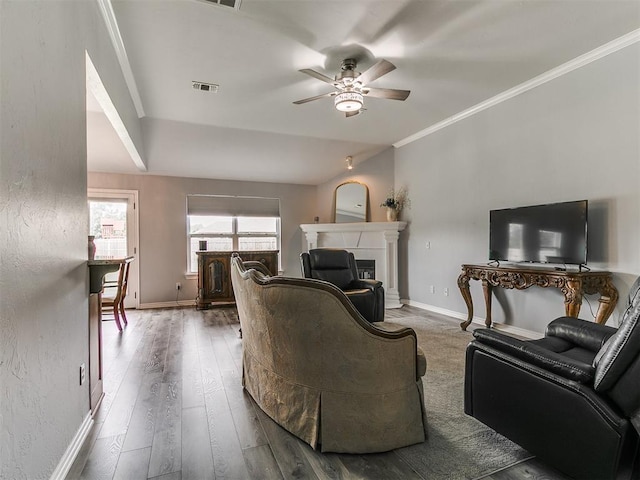 1401 Baycharter St, Norman, OK 73071 - living room featuring a ceiling fan, a fireplace, crown molding, and wood finished floors