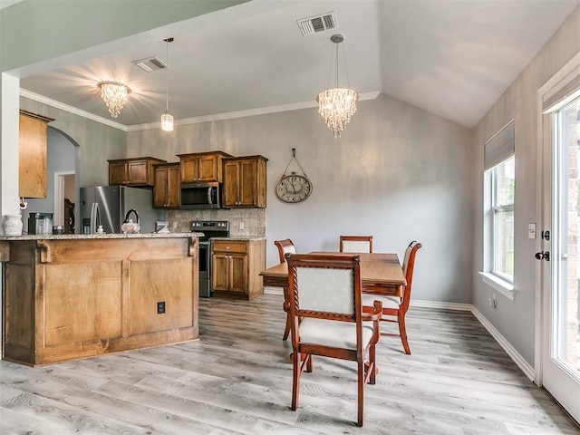 1401 Baycharter St, Norman, OK 73071 - kitchen with stainless steel appliances, a chandelier, light wood-style flooring, hanging light fixtures, and lofted ceiling