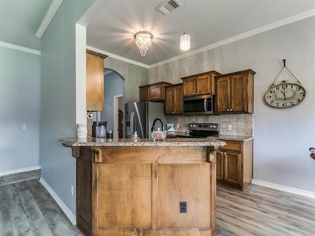 1401 Baycharter St, Norman, OK 73071 - kitchen featuring appliances with stainless steel finishes, light wood finished floors, arched walkways, stone counters, and ornamental molding