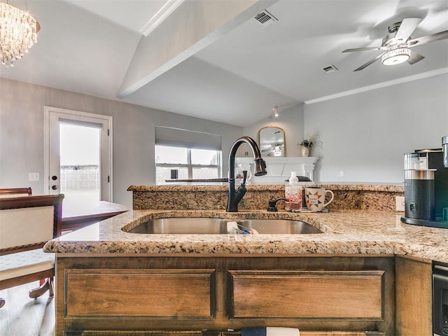 1401 Baycharter St, Norman, OK 73071 - kitchen featuring light stone countertops, a ceiling fan, vaulted ceiling, crown molding, and a chandelier