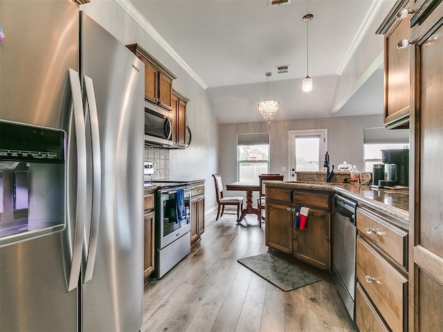 1401 Baycharter St, Norman, OK 73071 - kitchen with appliances with stainless steel finishes, crown molding, a peninsula, light wood-style flooring, and pendant lighting