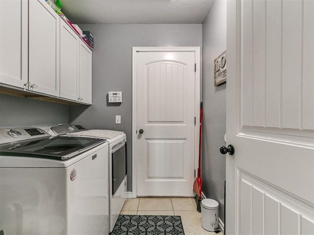 1401 Baycharter St, Norman, OK 73071 - washroom with washer and dryer, cabinet space, and light tile patterned floors