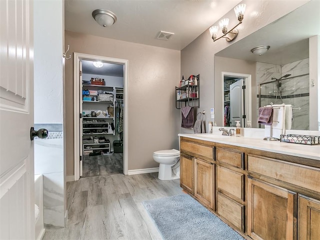 1401 Baycharter St, Norman, OK 73071 - bathroom with a shower stall, a spacious closet, vanity, and wood finished floors