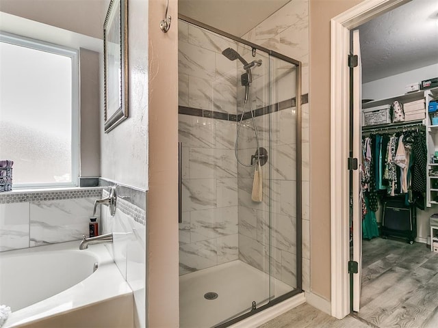 1401 Baycharter St, Norman, OK 73071 - full bath featuring a garden tub, a shower stall, a walk in closet, and wood finished floors