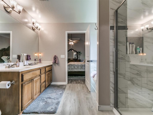 1401 Baycharter St, Norman, OK 73071 - ensuite bathroom featuring wood finished floors, a marble finish shower, and double vanity