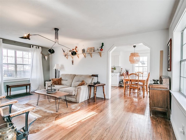 2647 NW 24th St, Oklahoma City, OK 73107 - living room featuring hardwood / wood-style floors and arched walkways