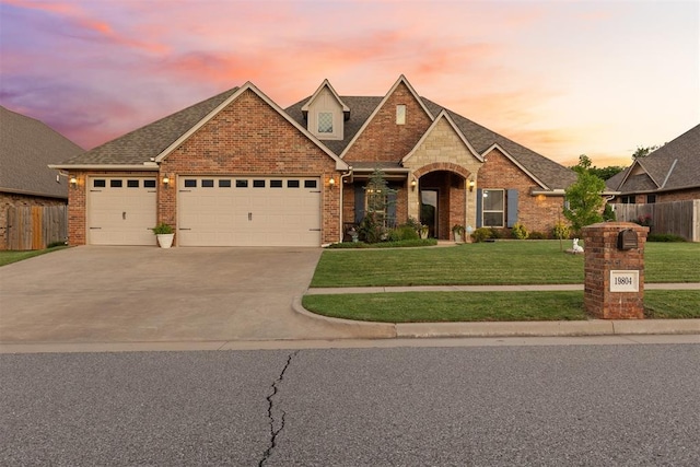 19804 Dalemead Way, Edmond, OK 73012 - view of front of home featuring an attached garage, brick siding, driveway, and a shingled roof