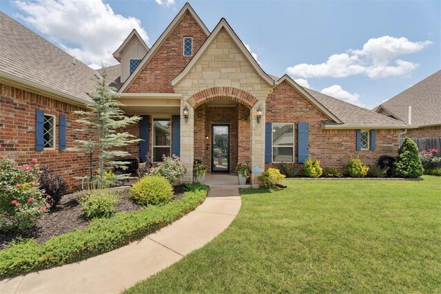 19804 Dalemead Way, Edmond, OK 73012 - tudor house with a front yard, brick siding, and roof with shingles