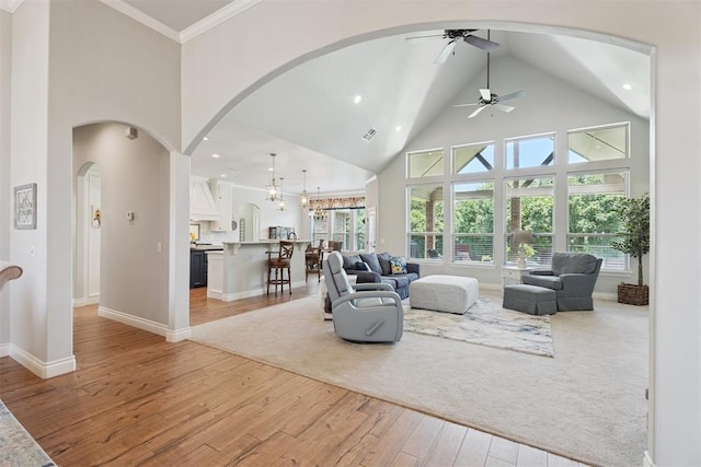 19804 Dalemead Way, Edmond, OK 73012 - living room featuring high vaulted ceiling, light wood-type flooring, a ceiling fan, arched walkways, and recessed lighting
