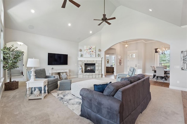 19804 Dalemead Way, Edmond, OK 73012 - carpeted living area with arched walkways, ceiling fan, high vaulted ceiling, recessed lighting, and a stone fireplace