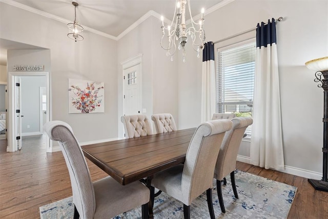 19804 Dalemead Way, Edmond, OK 73012 - dining area with a chandelier, ornamental molding, and wood finished floors