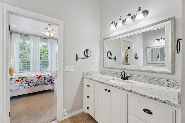 19804 Dalemead Way, Edmond, OK 73012 - bathroom with vanity, connected bathroom, and a ceiling fan