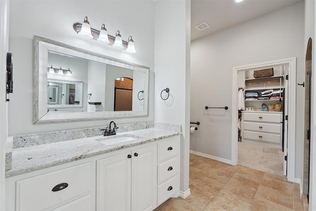 19804 Dalemead Way, Edmond, OK 73012 - bathroom featuring vanity and a spacious closet