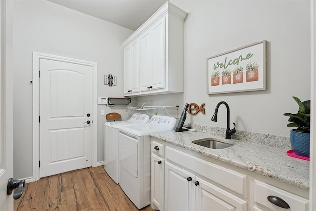 19804 Dalemead Way, Edmond, OK 73012 - laundry room featuring washing machine and dryer, cabinet space, and light wood-type flooring