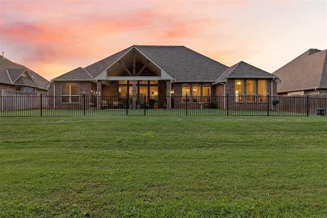 19804 Dalemead Way, Edmond, OK 73012 - back of property at dusk with brick siding and a fenced backyard