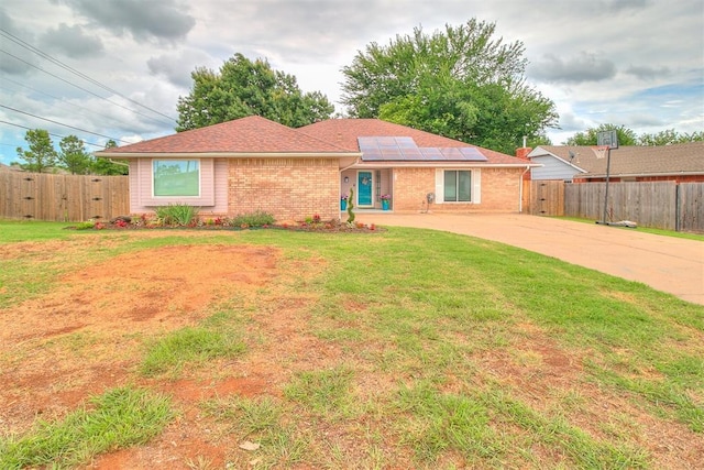 100 Three Oaks Dr, Midwest City, OK 73130 - single story home with solar panels, brick siding, and concrete driveway