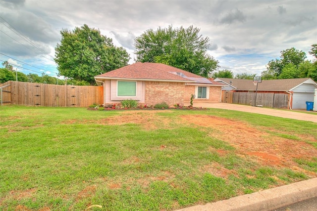 100 Three Oaks Dr, Midwest City, OK 73130 - view of front of home with solar panels, concrete driveway, and brick siding