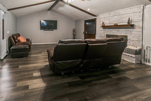 100 Three Oaks Dr, Midwest City, OK 73130 - cinema room with a textured ceiling, wood finished floors, a ceiling fan, and a brick fireplace