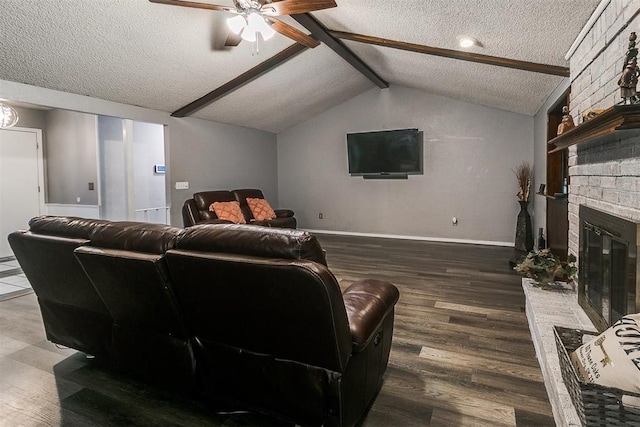 100 Three Oaks Dr, Midwest City, OK 73130 - home theater room with a textured ceiling, wood finished floors, a ceiling fan, and a fireplace