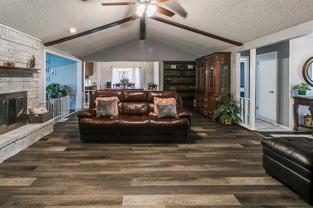 100 Three Oaks Dr, Midwest City, OK 73130 - living room featuring a textured ceiling, wood finished floors, ceiling fan, and a fireplace