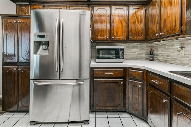 100 Three Oaks Dr, Midwest City, OK 73130 - kitchen with stainless steel appliances, light tile patterned flooring, backsplash, and light countertops