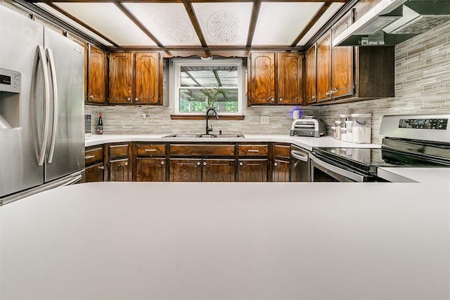 100 Three Oaks Dr, Midwest City, OK 73130 - kitchen with stainless steel appliances, under cabinet range hood, tasteful backsplash, light countertops, and dark brown cabinets