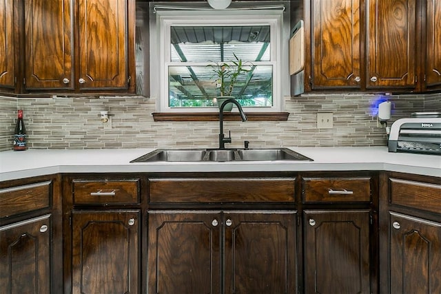100 Three Oaks Dr, Midwest City, OK 73130 - kitchen featuring light countertops, decorative backsplash, and dark brown cabinetry