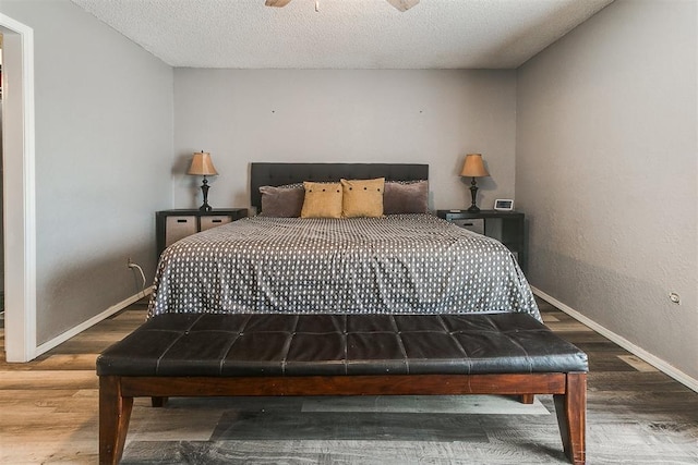 100 Three Oaks Dr, Midwest City, OK 73130 - bedroom with wood finished floors and a textured ceiling