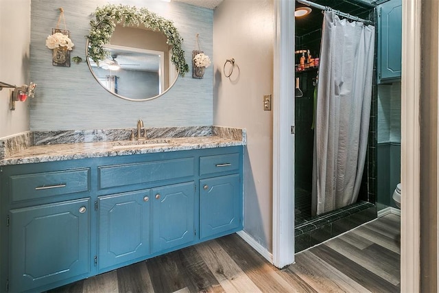 100 Three Oaks Dr, Midwest City, OK 73130 - bathroom featuring vanity, wood finished floors, and a stall shower