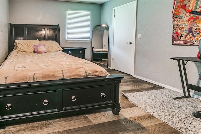100 Three Oaks Dr, Midwest City, OK 73130 - bedroom with wood finished floors and baseboards