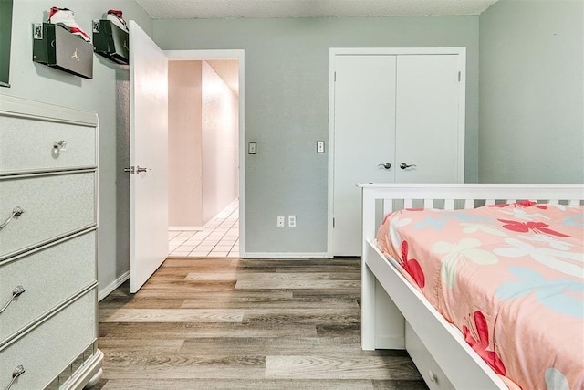 100 Three Oaks Dr, Midwest City, OK 73130 - bedroom featuring wood finished floors and a closet