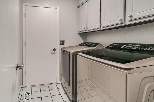 100 Three Oaks Dr, Midwest City, OK 73130 - washroom featuring washing machine and dryer, cabinet space, and light tile patterned floors