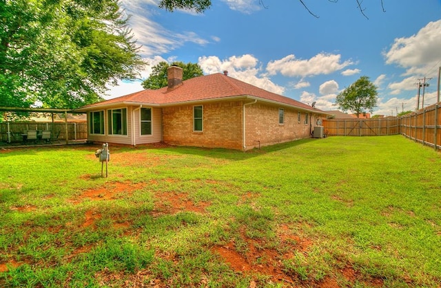 100 Three Oaks Dr, Midwest City, OK 73130 - back of house featuring a chimney, a fenced backyard, and brick siding