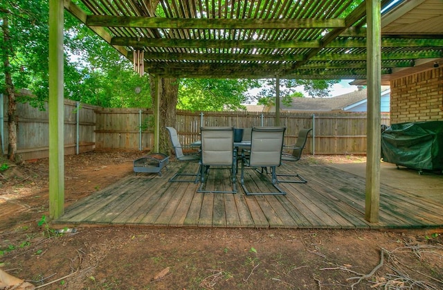 100 Three Oaks Dr, Midwest City, OK 73130 - wooden deck with outdoor dining area, a fenced backyard, a grill, and a pergola