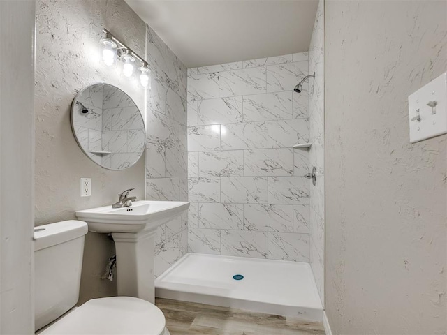 6617 NW 31st St, Bethany, OK 73008 - full bathroom with tiled shower, a textured wall, and wood finished floors