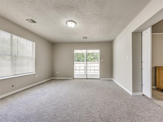 6617 NW 31st St, Bethany, OK 73008 - spare room featuring light carpet and a textured ceiling