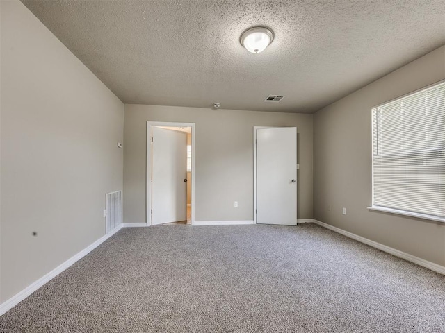 6617 NW 31st St, Bethany, OK 73008 - unfurnished bedroom featuring carpet flooring and a textured ceiling