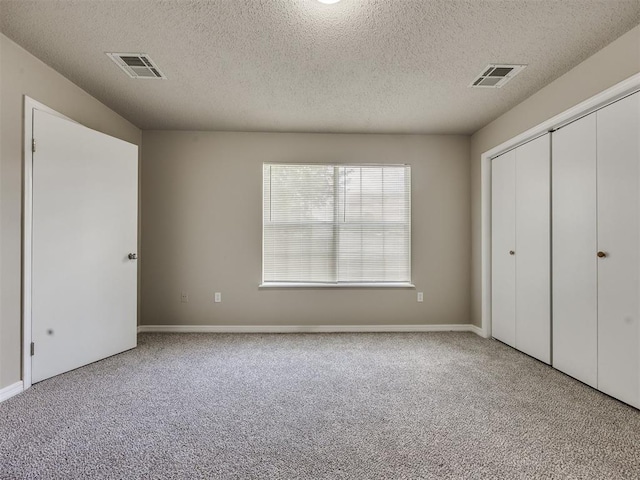 6617 NW 31st St, Bethany, OK 73008 - unfurnished bedroom featuring carpet floors, a textured ceiling, and a closet