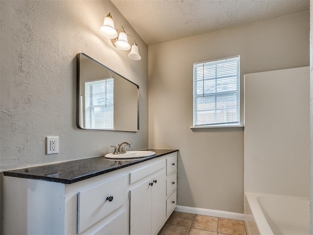6617 NW 31st St, Bethany, OK 73008 - full bath featuring vanity, tile patterned floors, a bath, and a textured ceiling