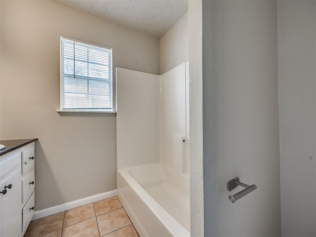 6617 NW 31st St, Bethany, OK 73008 - bathroom featuring vanity, tile patterned flooring, a textured ceiling, and shower / washtub combination