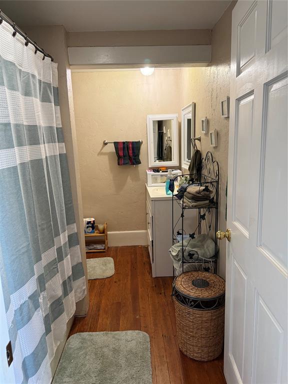342532 E 1020th Rd, Meeker, OK 74855 - bathroom with wood-type flooring, vanity, and a shower with curtain